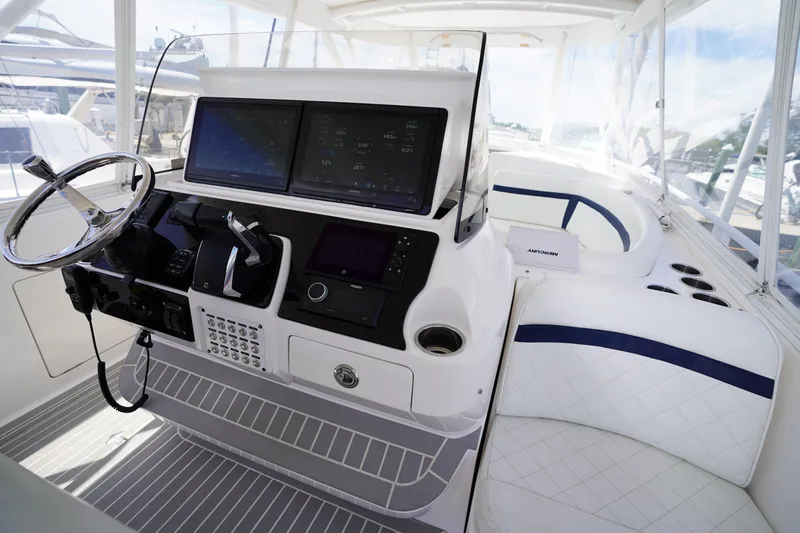 Slide: The Image of Helm of 2015 Intrepid 400 Cuddy boat with modern controls and seating. - 113