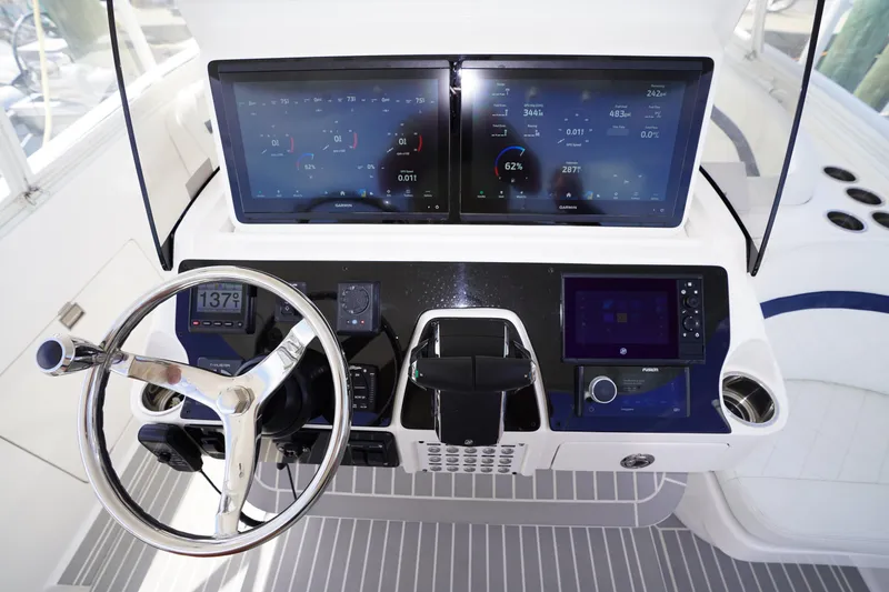 Slide: The Image of Cockpit of 2015 Intrepid 400 Cuddy with advanced navigation and control systems. - 114