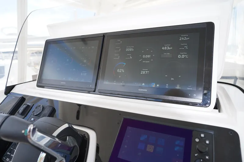 Slide: The Image of Dashboard of a 2015 Intrepid 400 Cuddy with Garmin navigation displays. - 115
