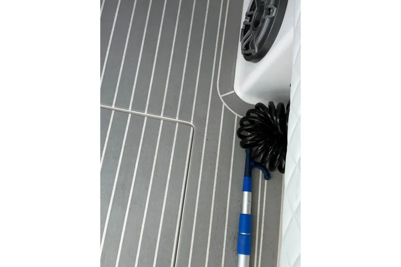 Slide: The Image of Deck of 2015 Intrepid 400 Cuddy with coiled hose and cleaning tool. - 12