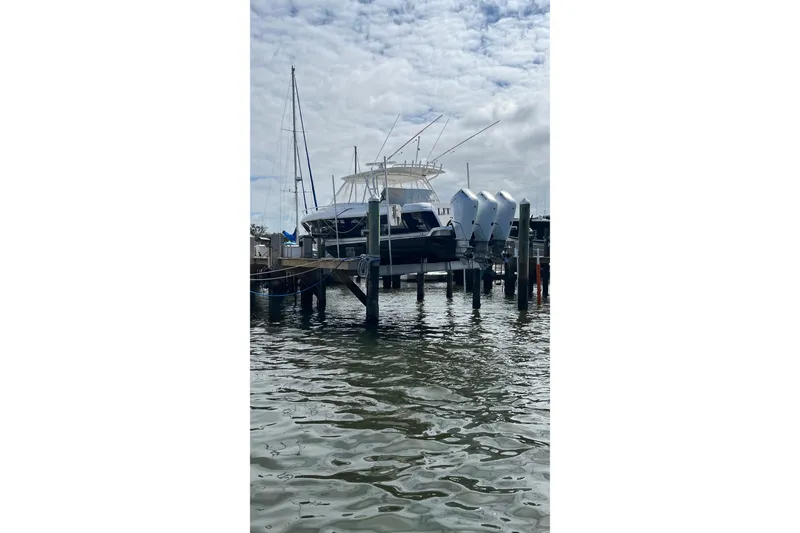 Slide: The Image of 2015 Intrepid 400 Cuddy boat docked with multiple outboard engines. - 127