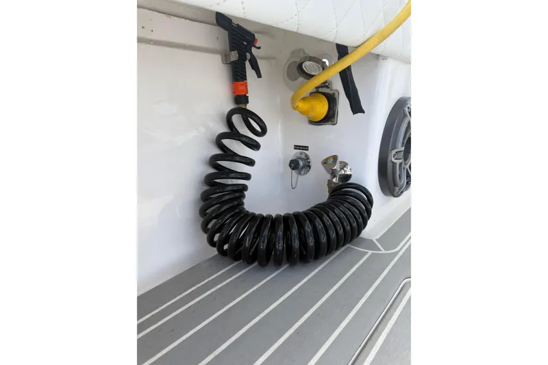 Slide: The Image of Coiled hose and fittings on 2015 Intrepid 400 Cuddy boat deck. - 13