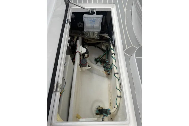 Slide: The Image of 2015 Intrepid 400 Cuddy boat storage compartment with visible wiring and components. - 14