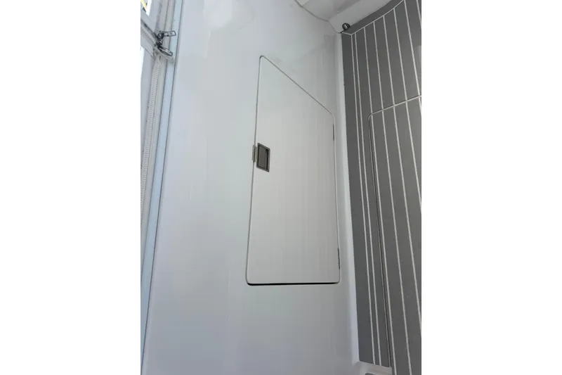 Slide: The Image of Interior view of 2015 Intrepid 400 Cuddy boat, featuring a sleek storage compartment. - 15