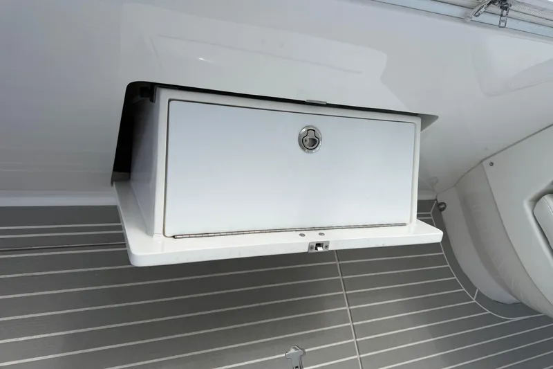 Slide: The Image of Storage compartment on a 2015 Intrepid 400 Cuddy boat interior. - 16