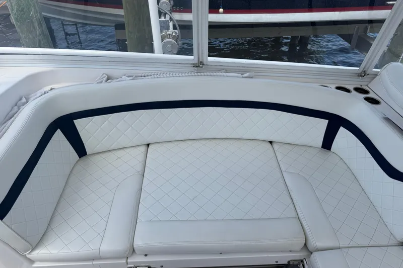 Slide: The Image of Luxurious white seating on a 2015 Intrepid 400 Cuddy boat, featuring quilted upholstery. - 18