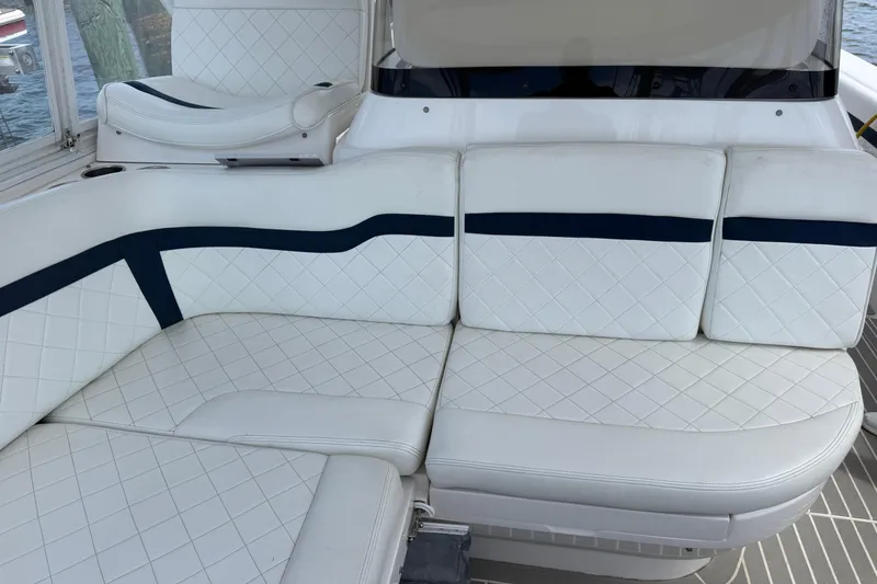 Slide: The Image of Luxurious white seating on 2015 Intrepid 400 Cuddy boat, featuring elegant diamond stitching. - 19