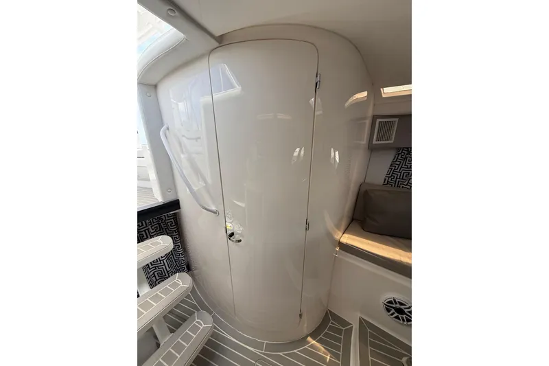 Slide: The Image of Interior of 2015 Intrepid 400 Cuddy boat, featuring sleek cabin door and seating area. - 21