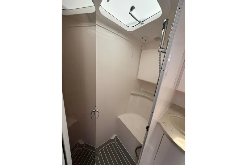 Slide: The Image of Shower area in 2015 Intrepid 400 Cuddy boat, featuring modern fixtures and skylight. - 28