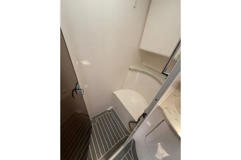 Slide: The Image of 2015 Intrepid 400 Cuddy bathroom interior with modern fixtures and striped flooring. - 29