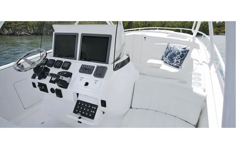 Slide: The Image of Hull of a 2015 Intrepid 400 Cuddy boat above water, showcasing sleek design. - 3