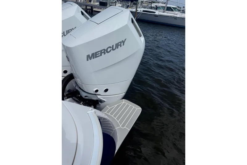 Slide: The Image of 2015 Intrepid 400 Cuddy with Mercury outboard engines docked on water. - 34