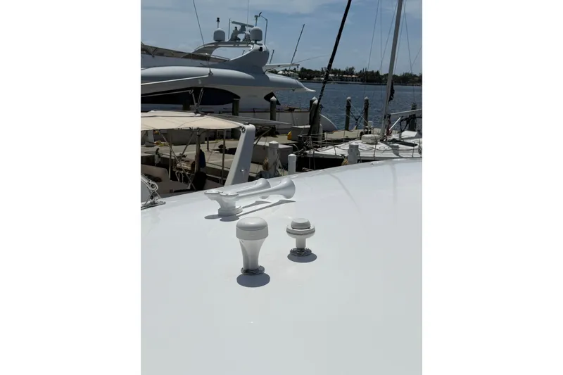Slide: The Image of 2015 Intrepid 400 Cuddy boat deck with marine equipment, docked at a marina. - 37