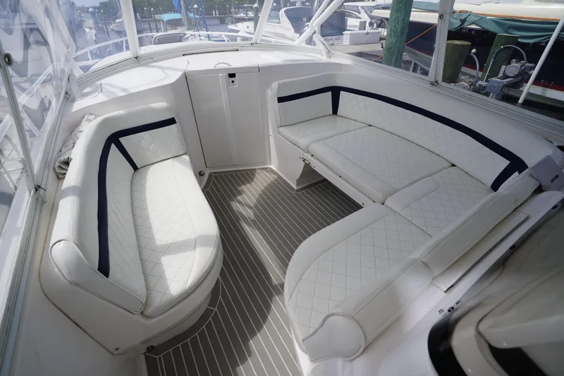 Slide: The Image of Luxurious seating area on a 2015 Intrepid 400 Cuddy boat, featuring white quilted upholstery. - 43