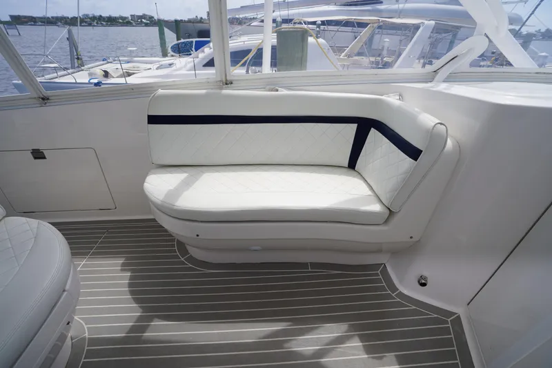 Slide: The Image of Interior of 2015 Intrepid 400 Cuddy boat with white cushioned seating. - 46