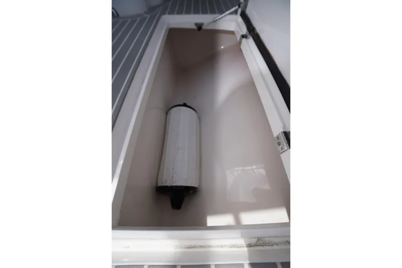 Slide: The Image of Storage compartment in a 2015 Intrepid 400 Cuddy boat, featuring a cylindrical object. - 49