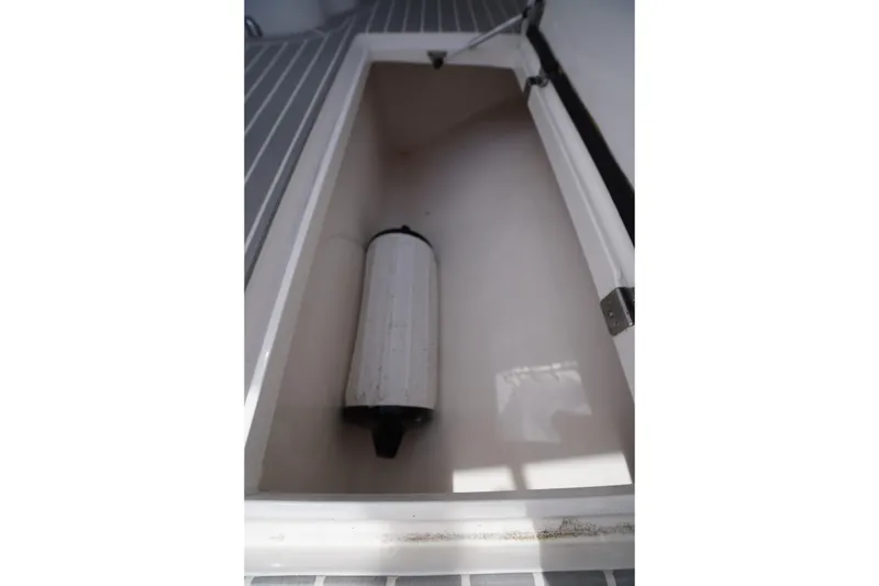 Slide: The Image of Storage compartment in 2015 Intrepid 400 Cuddy boat with a fender inside. - 50