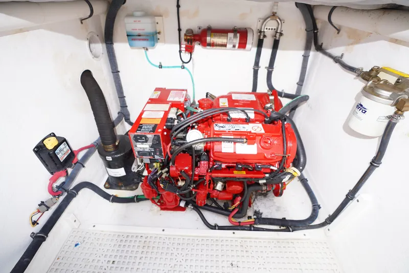 Slide: The Image of Engine room of a 2015 Intrepid 400 Cuddy boat with red machinery and wiring. - 51