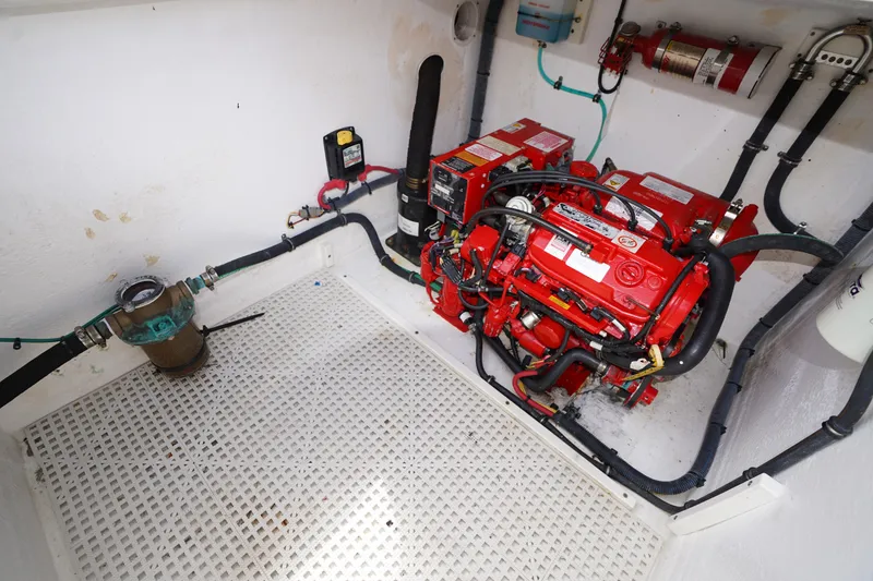 Slide: The Image of Engine room of 2015 Intrepid 400 Cuddy with red engine and fire extinguisher. - 52