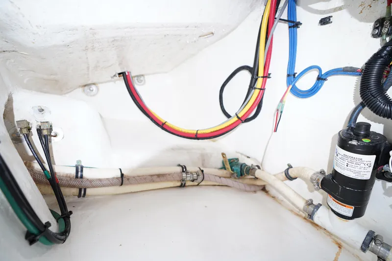 Slide: The Image of Engine compartment of a 2015 Intrepid 400 Cuddy with visible wiring and hoses. - 53