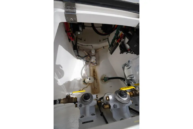 Slide: The Image of Engine compartment of a 2015 Intrepid 400 Cuddy boat, showcasing mechanical components. - 56