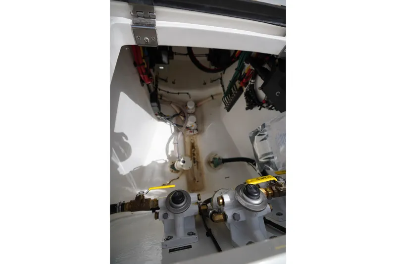 Slide: The Image of Engine compartment of a 2015 Intrepid 400 Cuddy boat, showcasing mechanical components. - 57