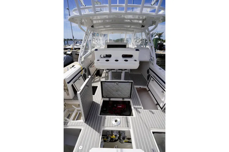 Slide: The Image of 2015 Intrepid 400 Cuddy boat interior with open storage compartments and seating. - 63