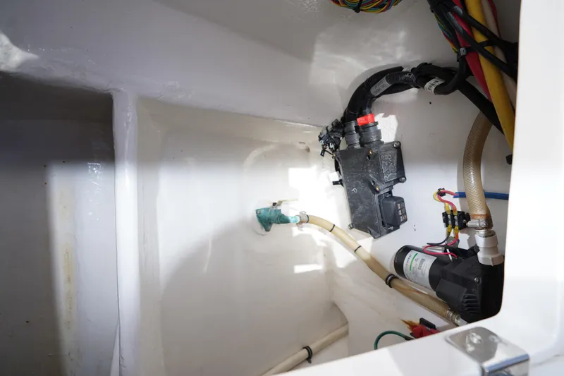 Slide: The Image of 2015 Intrepid 400 Cuddy boat interior wiring and plumbing components. - 64