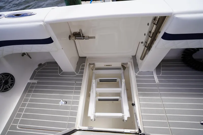 Slide: The Image of 2015 Intrepid 400 Cuddy boat deck with open hatch and ladder. - 69