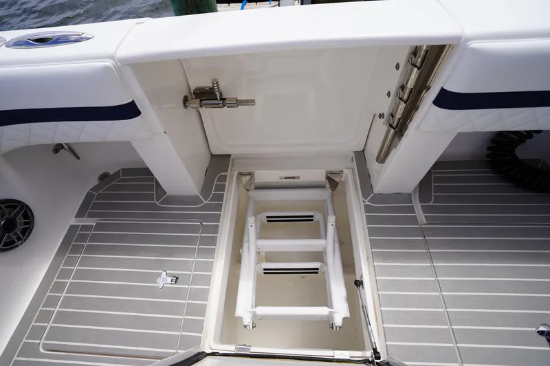 Slide: The Image of 2015 Intrepid 400 Cuddy boat deck with open hatch and ladder. - 70