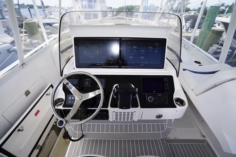 Slide: The Image of Helm of 2015 Intrepid 400 Cuddy with advanced navigation displays and controls. - 72