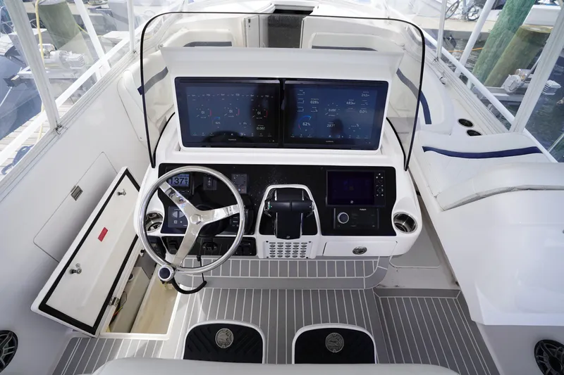 Slide: The Image of Cockpit of 2015 Intrepid 400 Cuddy with modern navigation displays and steering wheel. - 73