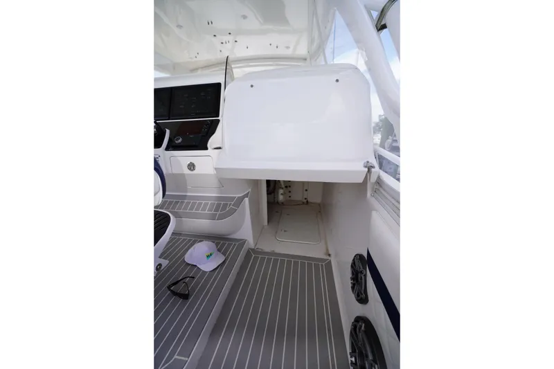Slide: The Image of Interior view of 2015 Intrepid 400 Cuddy boat cockpit with helm and seating area. - 77