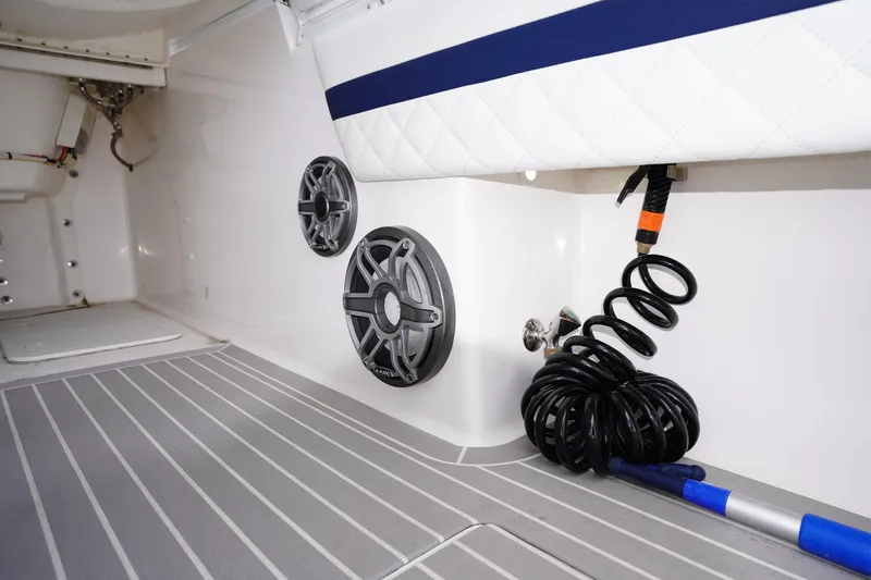 Slide: The Image of Interior of 2015 Intrepid 400 Cuddy boat with speakers and coiled hose. - 78