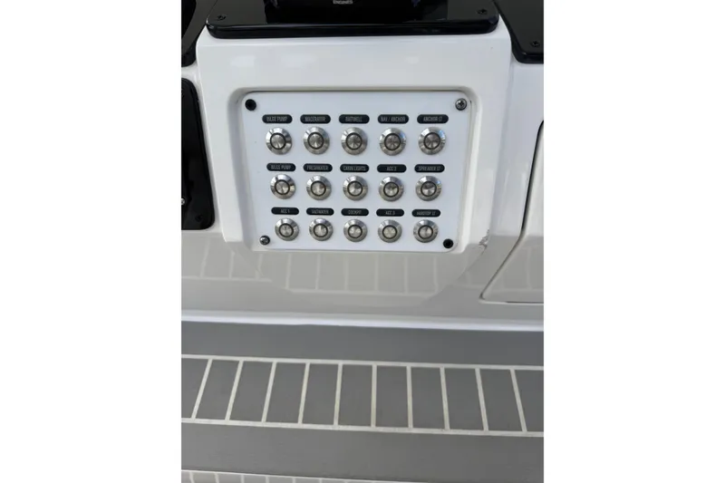 Slide: The Image of Control panel on a 2015 Intrepid 400 Cuddy boat with labeled switches. - 8