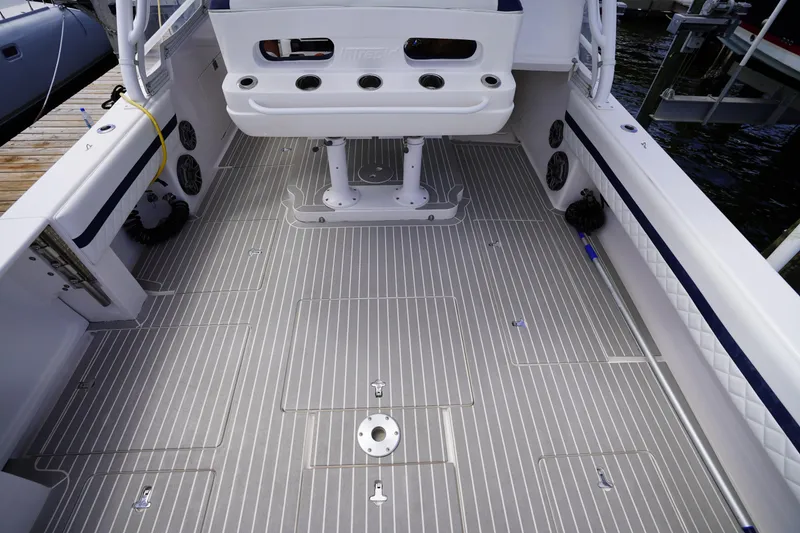 Slide: The Image of 2015 Intrepid 400 Cuddy boat deck with seating and storage compartments. - 80