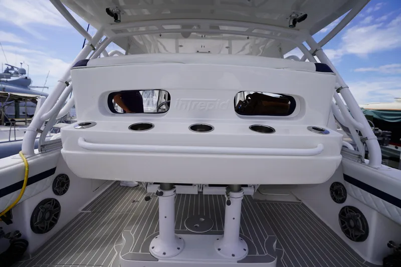 Slide: The Image of 2015 Intrepid 400 Cuddy boat interior with rod holders and seating area. - 81