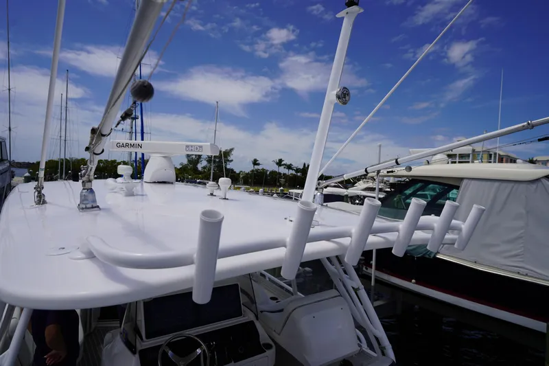 Slide: The Image of 2015 Intrepid 400 Cuddy boat with Garmin radar, docked under a clear blue sky. - 82