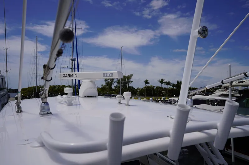 Slide: The Image of 2015 Intrepid 400 Cuddy boat with Garmin xHD2 radar, docked under a blue sky. - 83