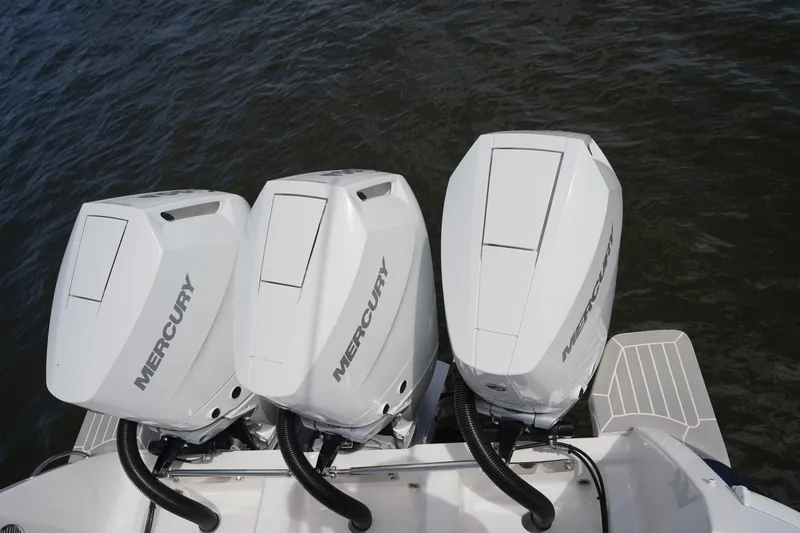 Slide: The Image of Triple Mercury outboard engines on a 2015 Intrepid 400 Cuddy boat. - 86