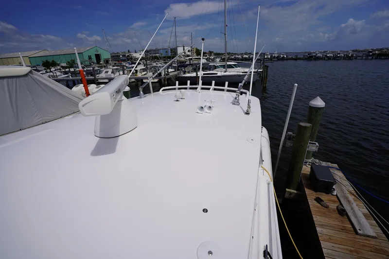 Slide: The Image of 2015 Intrepid 400 Cuddy boat docked at marina under clear blue sky. - 89