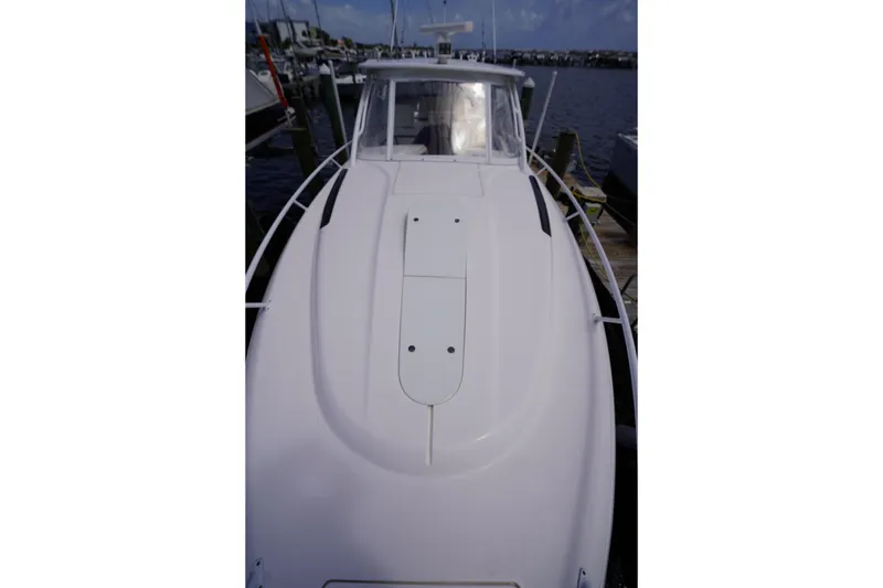 Slide: The Image of 2015 Intrepid 400 Cuddy boat docked at marina, viewed from bow. - 92
