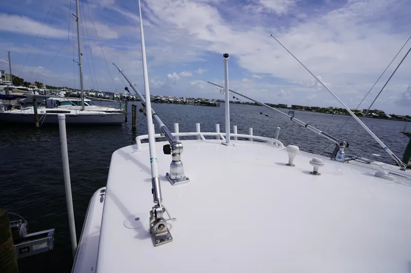 Slide: The Image of 2015 Intrepid 400 Cuddy boat docked at marina under clear sky. - 94
