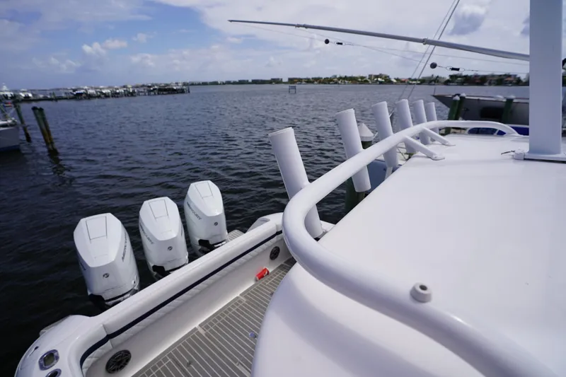 Slide: The Image of 2015 Intrepid 400 Cuddy boat with multiple outboard engines on a calm waterway. - 96