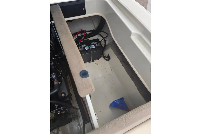 Slide: The Image of 2005 Sea Ray 200 Bow Rider engine compartment with battery and funnel visible. - 11
