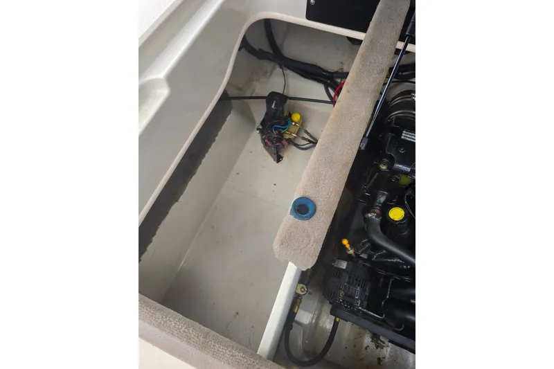 Slide: The Image of Engine compartment of a 2005 Sea Ray 200 Bow Rider boat, showing mechanical components. - 12