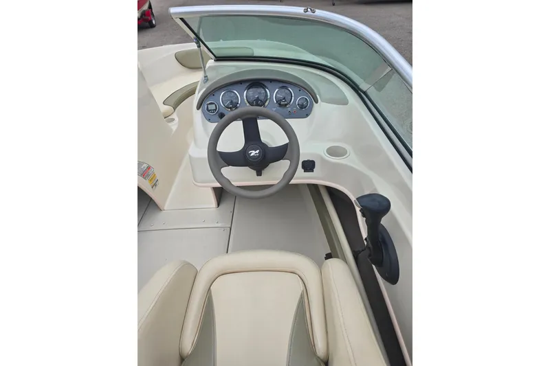 Slide: The Image of 2005 Sea Ray 200 Bow Rider dashboard with steering wheel and gauges. - 7