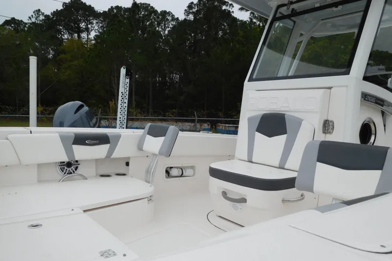 Slide: The Image of 2023 Robalo 266 Cayman boat interior with cushioned seating and modern design. - 4