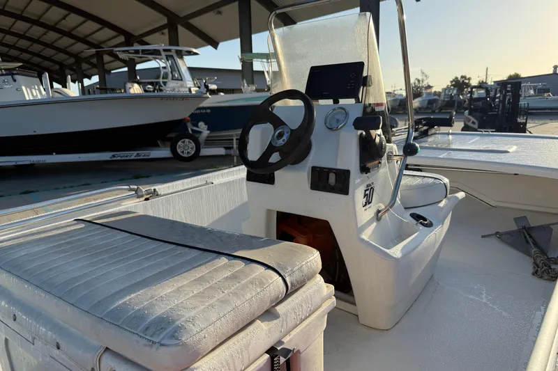 Slide: The Image of 2017 Mako Pro Skiff 17 CC boat interior with steering console and seating. - 14