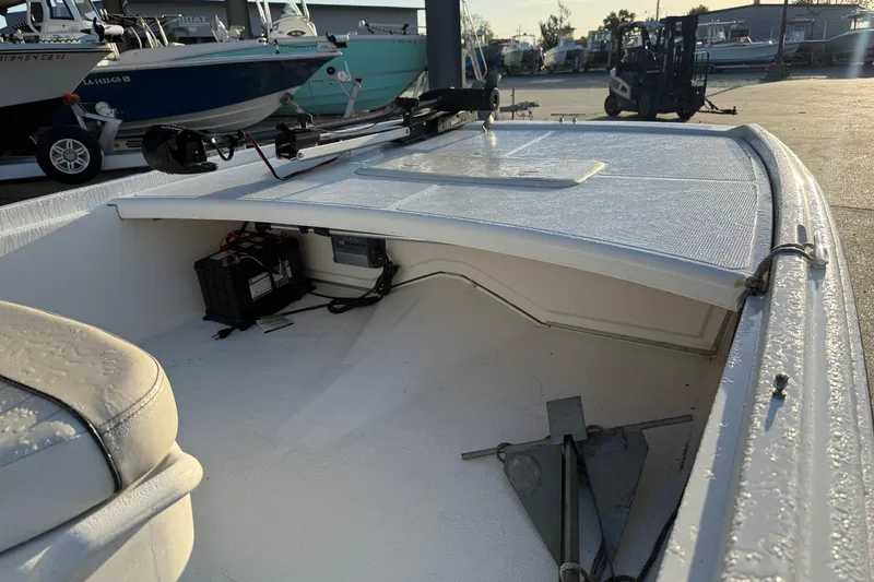 Slide: The Image of 2017 Mako Pro Skiff 17 CC boat interior with anchor and battery storage. - 15